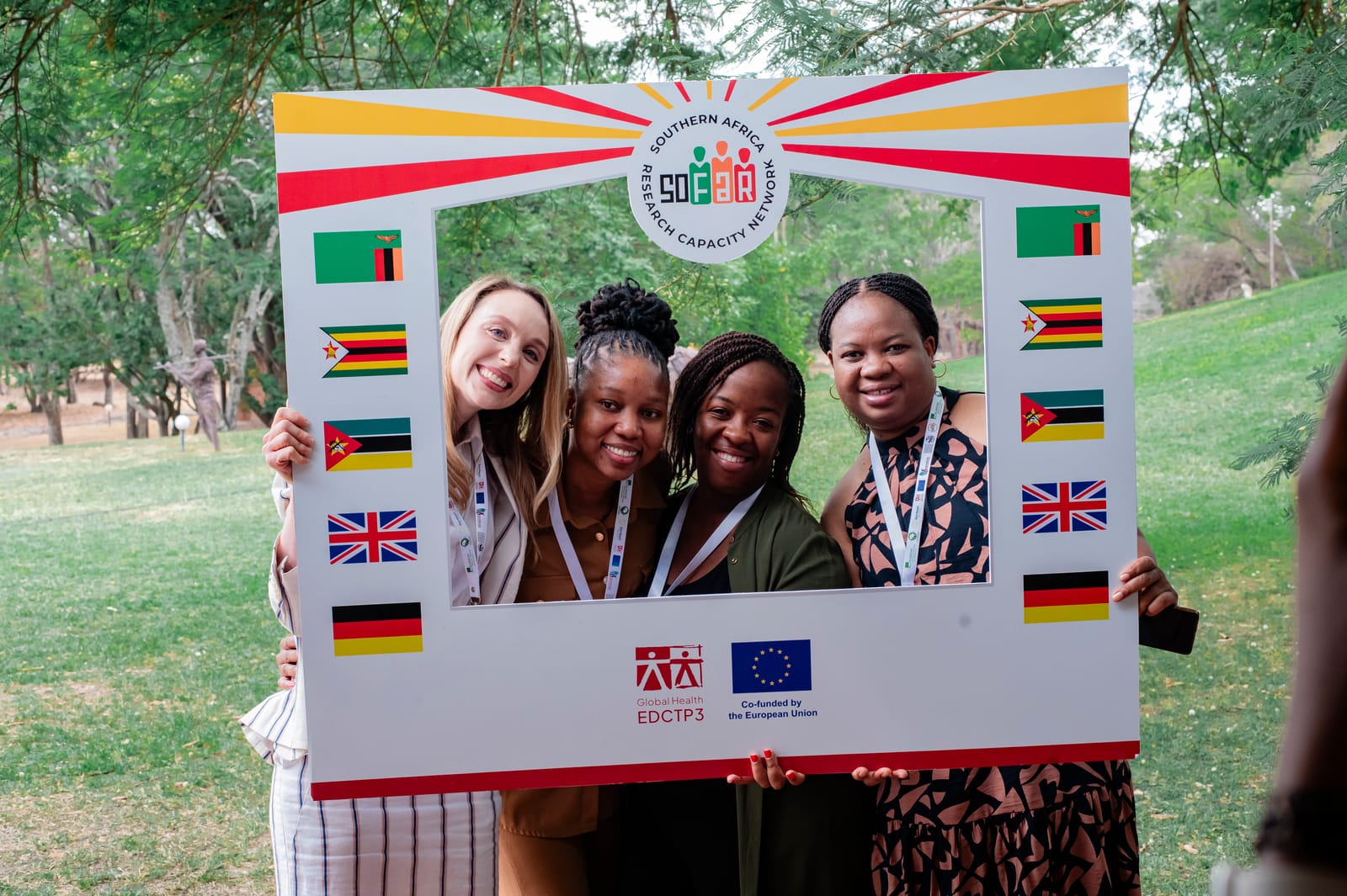 Four SOFAR fellows holding the programme photo frame at a network meeting